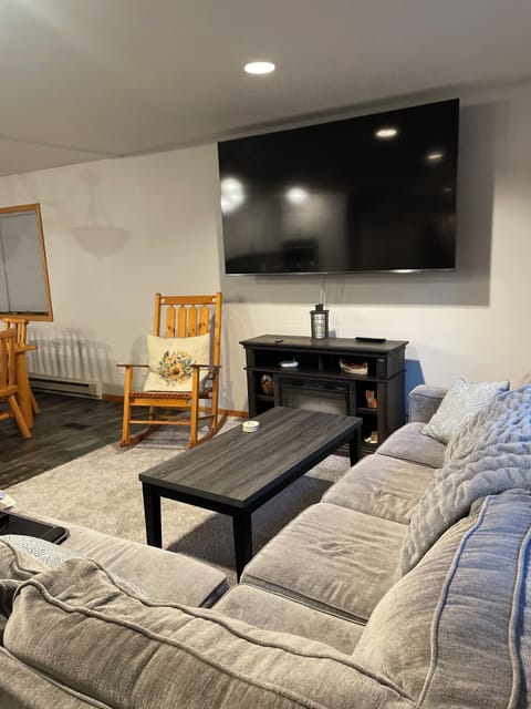 Living room on main floor with 90” tv.