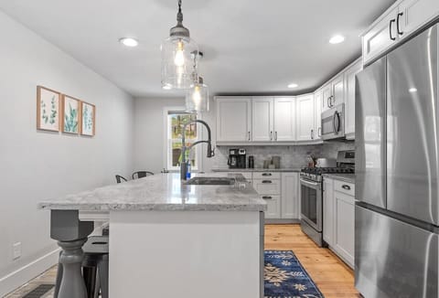 An attractive and refined ambiance is created by the seamless integration of stainless steel equipment, polished surfaces, and sleek cabinetry.