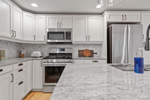 Equipped with top-of-the-line appliances, this kitchen is a chef`s dream. A stainless steel refrigerator, a gas or electric range, a built-in oven, and a dishwasher make cooking and cleaning a breeze.