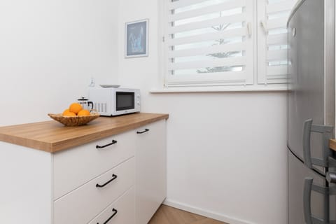 Functional kitchen with white cabinets, a modern oven, and plenty of cooking space.