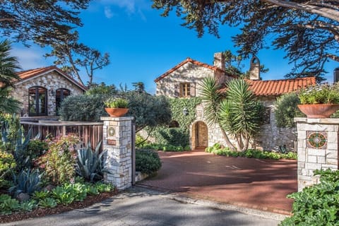 Driveway entrance leads to property with gate for security. Property is fully fenced. 

Parking:
              - Parking pad with two parking spaces to the left of the property as you drive in
              -Two car garage with additional parking 
              -Parking in courtyard for 2-3 more cars
             -On street parking
