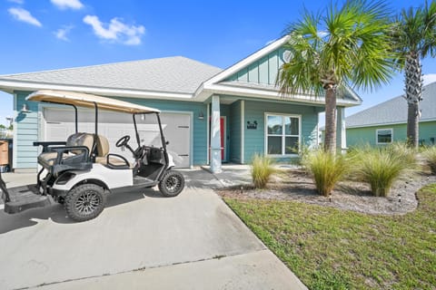 Charming coastal cottage with golf cart included for easy beach access and neighborhood exploration.