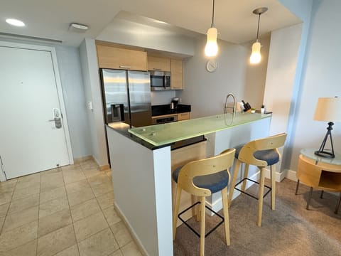 Modern dining area connected to a fully equipped kitchen.