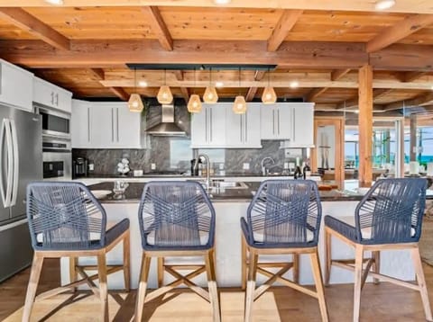 This coastal contemporary kitchen combines style and functionality perfect for cooking, entertaining, and enjoying the ocean breeze