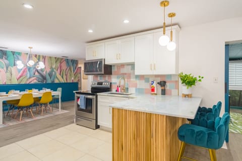 Open concept kitchen with all the utensils, pots, pans, blender, rice maker, toaster, etc you would expect to be able to cook a great meal for your family and friends! 2 dining rooms and bar-top seating can accommodate your entire group!