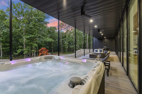 Outdoor Lounge: Soak in the hot tub with stunning forest views and evening sky magic!