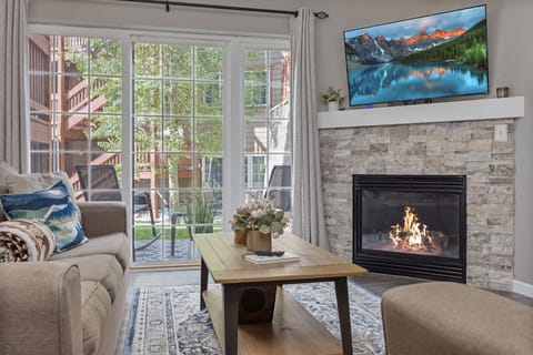 Living room area with ample seating, sleeper sofa, gas fireplace, large Roku tv
