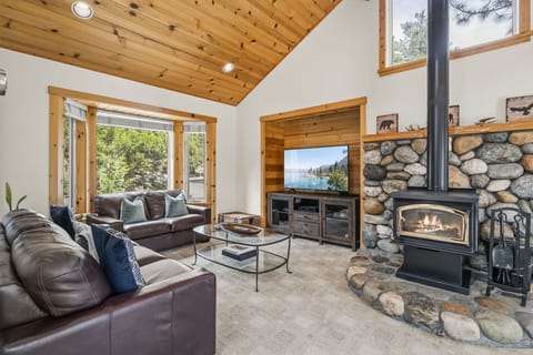 Living Room with wood-burning fireplace, and rustic river-rock hearth