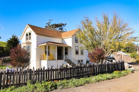 Zia's Farmhouse at Stempe Creek Ranch! Outdoor entertainment area with adirondack chairs, gas firepit, dining table, enclosed garden, and gas BBQ.
