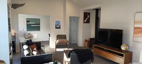 Main Living, opens to office with sofa bed and door to passage & east door.