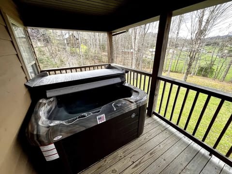 Unwind in the bubbling hot tub with serene forest views—pure relaxation awaits!