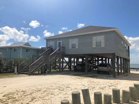 Waterfront property elevated on stilts with covered parking below and easy beach access steps away from your door.