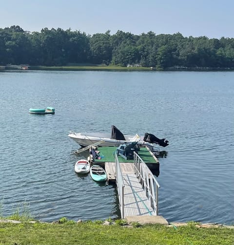 Dock with lounge chairs, paddle boards and raft 