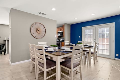 Unite around the table in our inviting dining space, furnished with two tables and enough chairs to accommodate gatherings of family and friends, ensuring memorable dining moments.