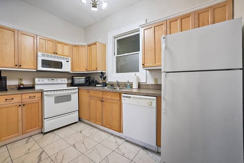 Experience culinary bliss in our fully stocked kitchen at Downtown Digs. Whip up delicious meals with ease using top-of-the-line appliances and ample counter space. Your culinary adventures start here!