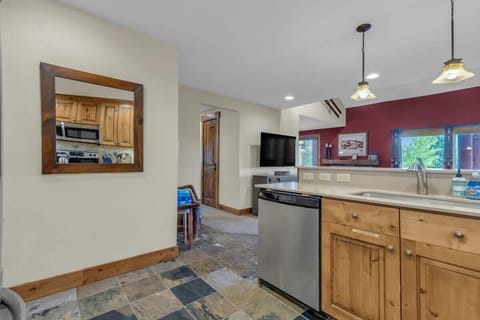 The view from the kitchen toward the living room and the hallway where you will find two bedrooms and the shared bathroom.
