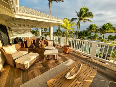 Large balcony with lounge and outdoor dining areas.