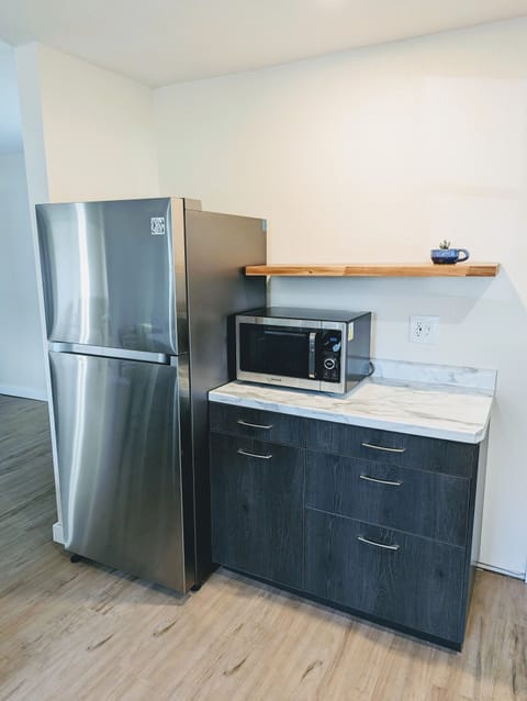Full-size refrigerator with microwave oven.