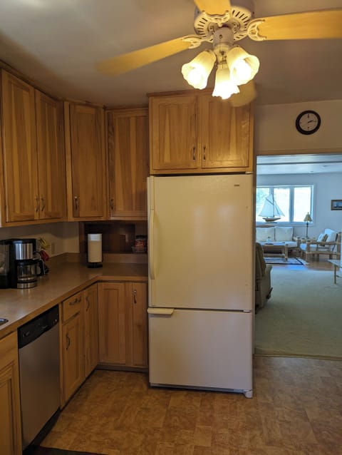 kitchen storage with dishwasher and refrigerator.