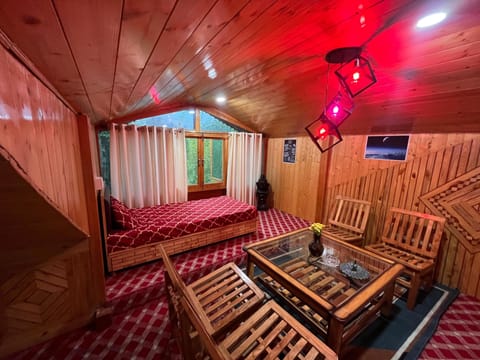 Living area with 4-seater dinning and dressing table, featuring garden view.