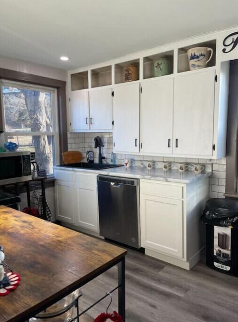Kitchen with dishwasher, microwave, stove, full refrigerator,  bar seating, etc.