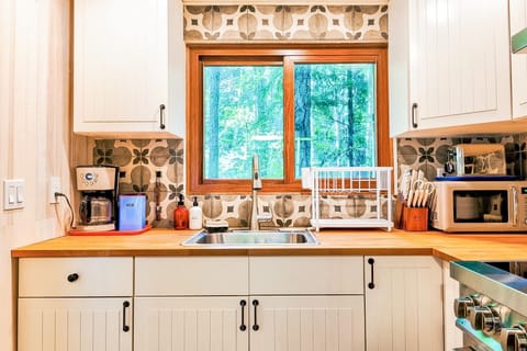 Cute and colorful kitchen with complimentary coffee, cocoa and tea.