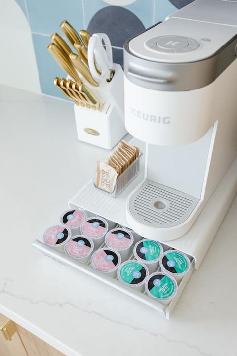 Stylish bath detail w/ sleek tile, open shelving & spa-like simplicity.