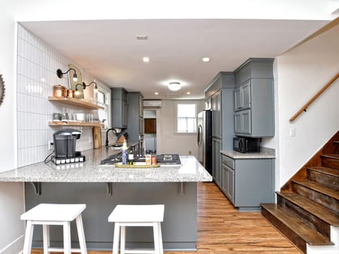 Kitchen island with seating, stairs to the second story