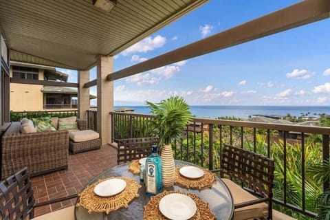 Ocean‑view lanai with comfortable seating and dining space, ideal for relaxing with meals or drinks while overlooking Kapalua's lush coastline.