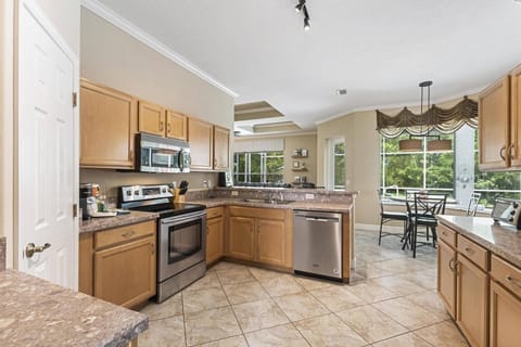 The kitchen area is a culinary haven, boasting ample counter space for easy meal preparation. Equipped with modern amenities.