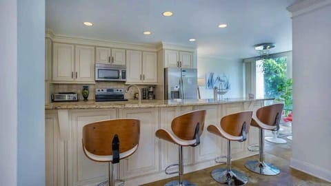 Gather Around the Island - The spacious kitchen features a central island with seating, making it the perfect spot for casual meals, morning coffee, or chatting while you cook.