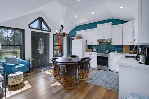 View of the open living area and rear of entry door.