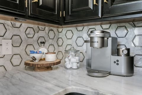 A stocked Keurig coffee station with coffee, sugar and creamer and plenty of coffee cups!