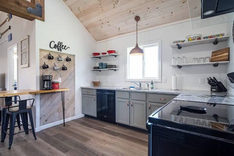 Full kitchen with coffee station with a full-sized coffee pot.