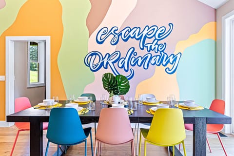 Embrace your individuality on our stylish dining table with multicolored chairs