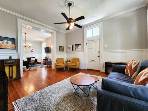 Enter into a large sitting room that flows into the living room with Roku tv.