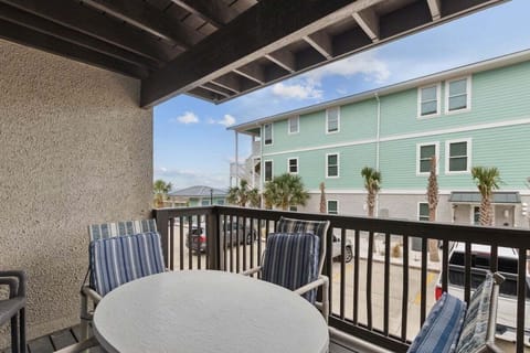 Relax on the private covered balcony with outdoor dining seating at Deep Blue Sea.
