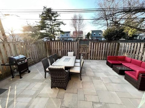 Step outside to enjoy the outdoor patio featuring a 8 person fire-pit dining table and lounge seating.