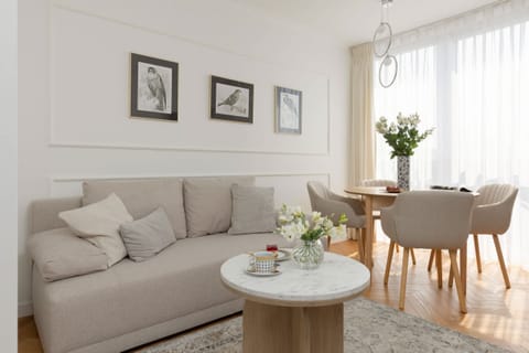Relax in the stylish living room with a comfortable sofa and modern decor.