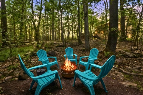 Laid-back vibes in the woods! These teal Adirondack chairs are ready for your fireside stories, laughter, and unforgettable memories.