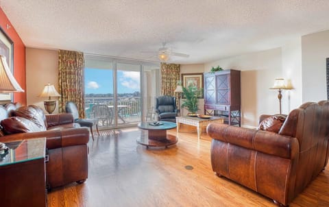 Spacious living area with cozy leather seating and warm lighting

