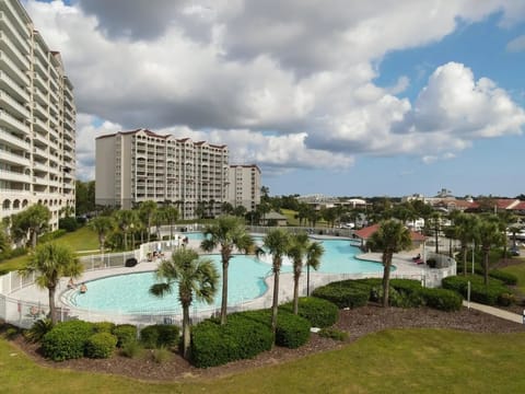 Resort views with tropical palms and sparkling pool below