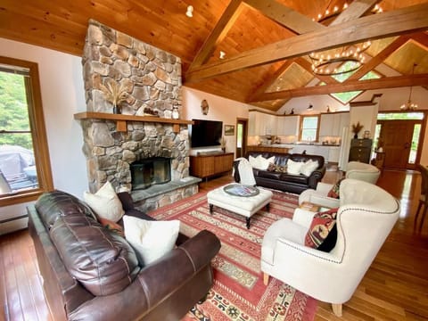 A cozy sitting area with a beautiful fireplace, a smart TV and more