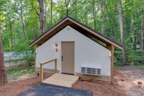 Spacious glamping tent featuring a private hot tub, king bed, and scenic views. Experience luxury camping in the heart of North Alabama.