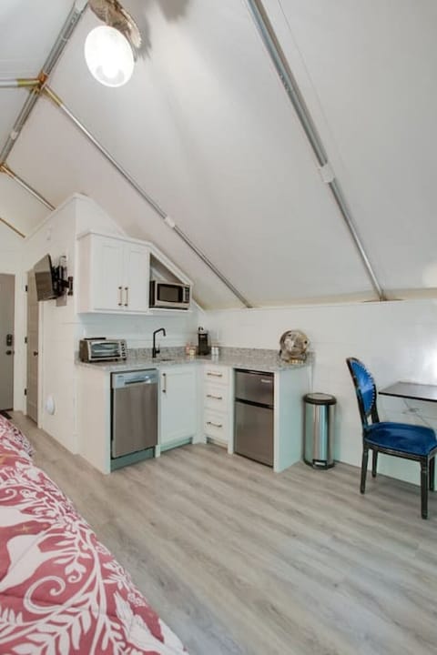 Spacious glamping tent with a complete kitchenette including a dishwasher and modern appliances, paired with a tasteful decor for a unique and enjoyable getaway