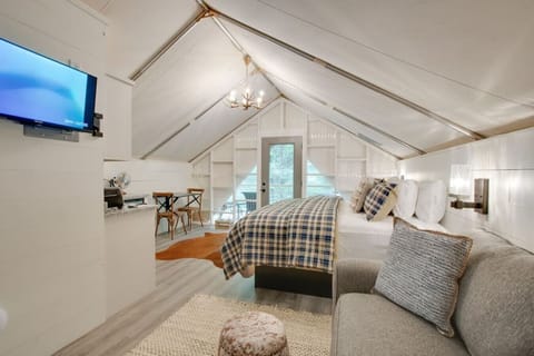 Spacious glamping tent featuring a private hot tub, king bed, and scenic views. Experience luxury camping in the heart of North Alabama.