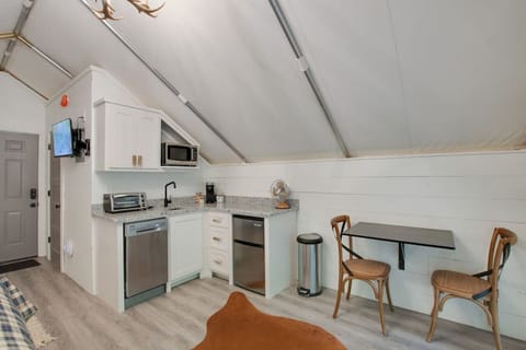 Glamping tent with a tasteful and fun décor, dining space for a meal in, perfect for fun-filled evenings and relaxation in nature.