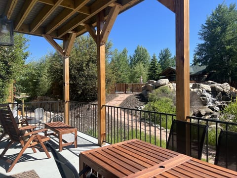 Back deck view towards neighborhood pool & waterfall.  Table expands to seat 10