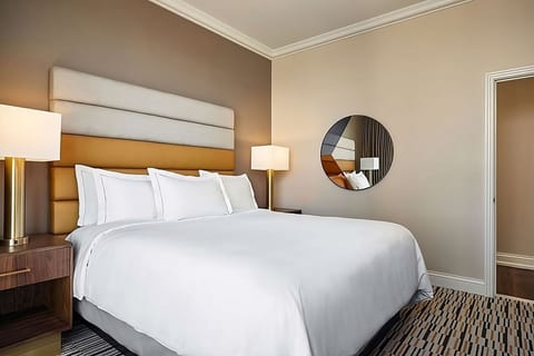 Relax in a modern bedroom with warm lighting and quiet vibes.