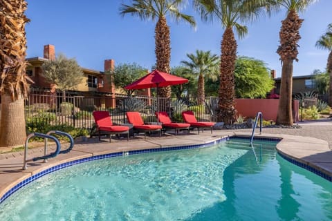 Cool off in a quiet corner pool framed by palms.